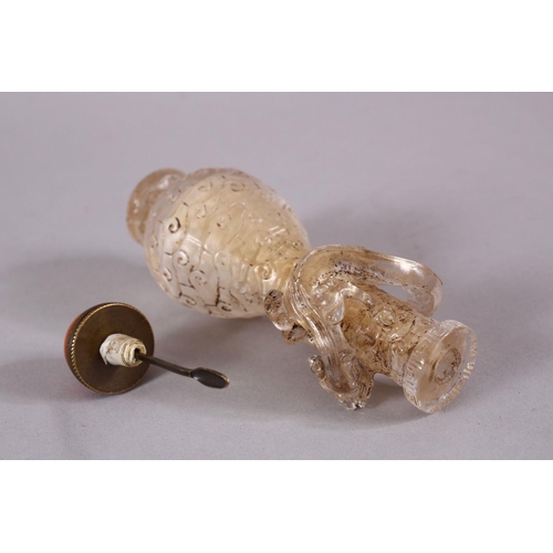 72 - A CHINESE ROCK CRYSTAL STYLE PEKING GLASS CARVED SNUFF BOTTLE, carved with archaic style with a moul... 