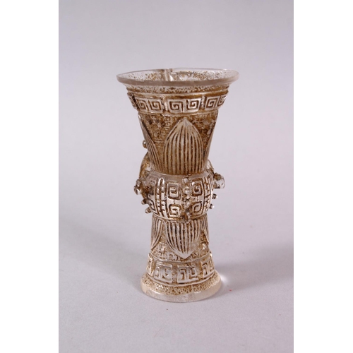 73 - A CHINESE ROCK CRYSTAL STYLE PEKING GLASS CARVED CUP, carved with archaic style, with a best emergin... 