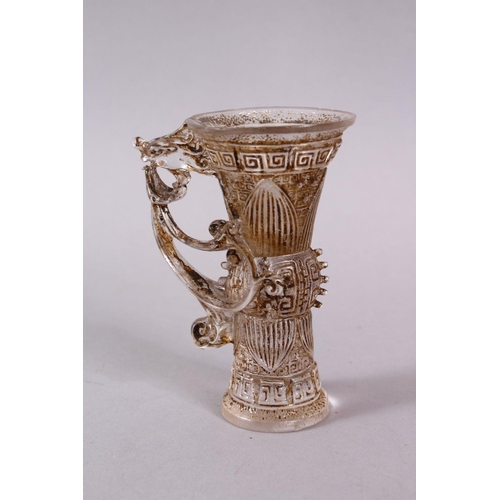 73 - A CHINESE ROCK CRYSTAL STYLE PEKING GLASS CARVED CUP, carved with archaic style, with a best emergin... 