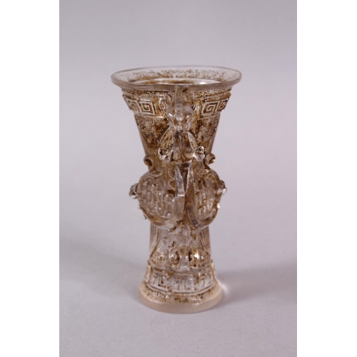 73 - A CHINESE ROCK CRYSTAL STYLE PEKING GLASS CARVED CUP, carved with archaic style, with a best emergin... 