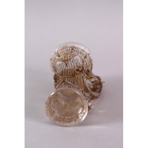 73 - A CHINESE ROCK CRYSTAL STYLE PEKING GLASS CARVED CUP, carved with archaic style, with a best emergin... 