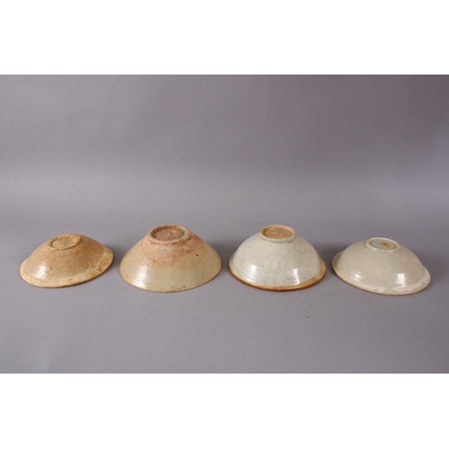 83 - FOUR EARLY CHINESE POTTERY BOWLS, 17.5cm down to 15.5cm.