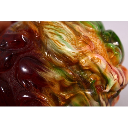 94 - A CHINESE CARVED BAKELITE OR CHERRY AMBER ZODIAC BALL, carved with animals, 9cm diameter.