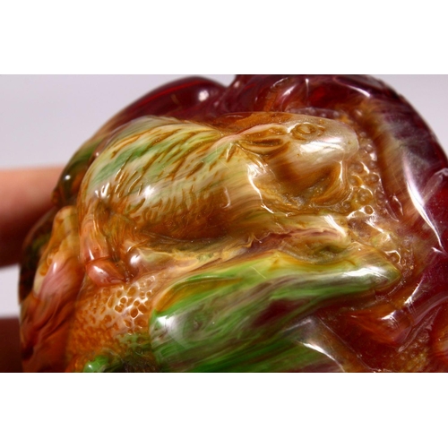 94 - A CHINESE CARVED BAKELITE OR CHERRY AMBER ZODIAC BALL, carved with animals, 9cm diameter.