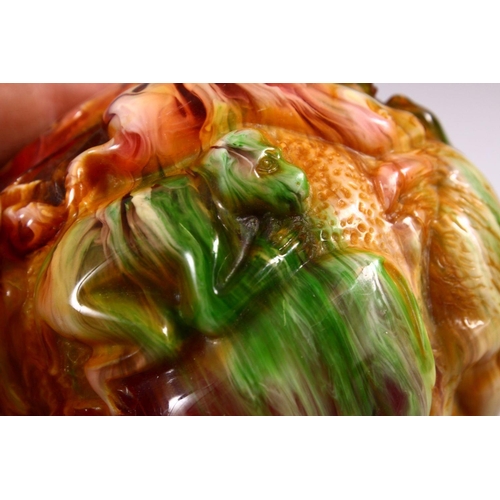 94 - A CHINESE CARVED BAKELITE OR CHERRY AMBER ZODIAC BALL, carved with animals, 9cm diameter.