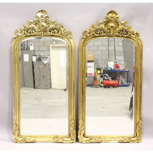 1 - A PAIR OF GILT RECTANGULAR UPRIGHT MIRRORS with scroll decoration, 6 feet 2 inches high x 3 feet wid... 