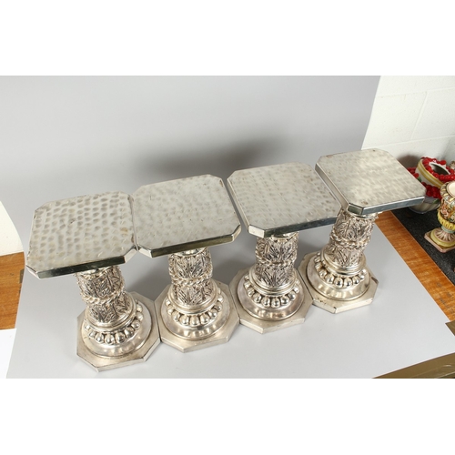 14 - A SET OF FOUR SILVERED SQUARED TOP STANDS on octagonal bases, 15.5 in. high.