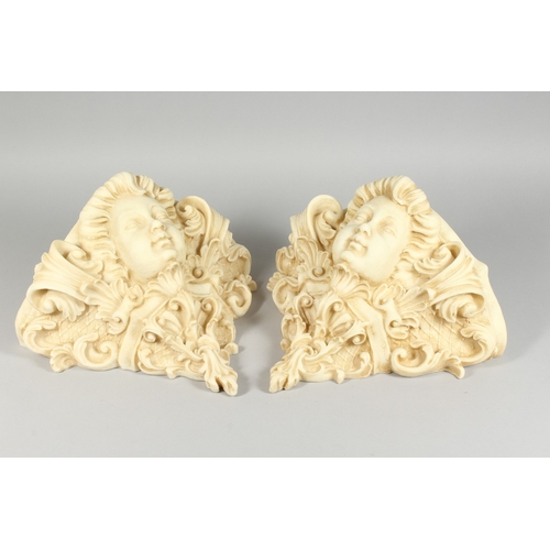 19 - A PAIR OF COMPOSITION WALL POCKETS with mask and scrolls, 1 ft. 2 in. wide.