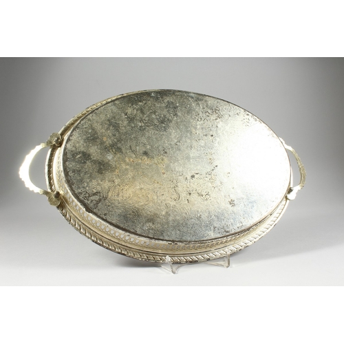 25 - A TWO HANDLED OVAL PLATED TRAY, 1 ft. 2 in. long.