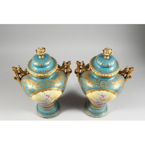 26 - A PAIR OF GERMAN BONN TWO HANDLED VASES with blue and gilt ground painted with reverse panels of flo... 