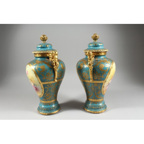 26 - A PAIR OF GERMAN BONN TWO HANDLED VASES with blue and gilt ground painted with reverse panels of flo... 