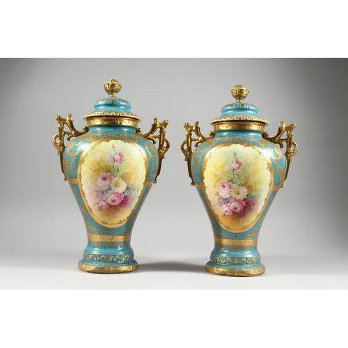 26 - A PAIR OF GERMAN BONN TWO HANDLED VASES with blue and gilt ground painted with reverse panels of flo... 