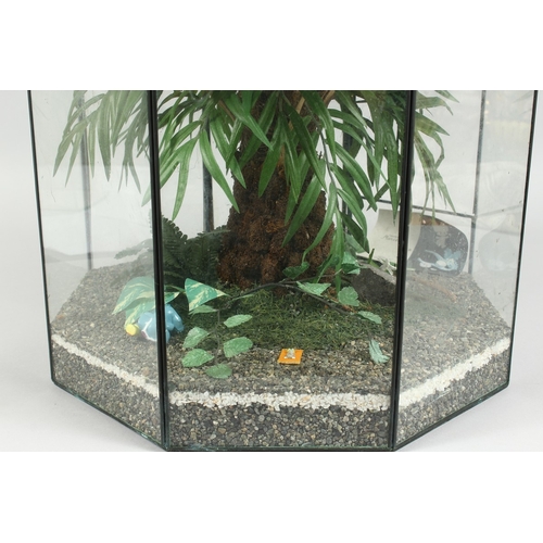 33 - A TERRARIUM  with plastic flowers 1 ft. 5 in. high