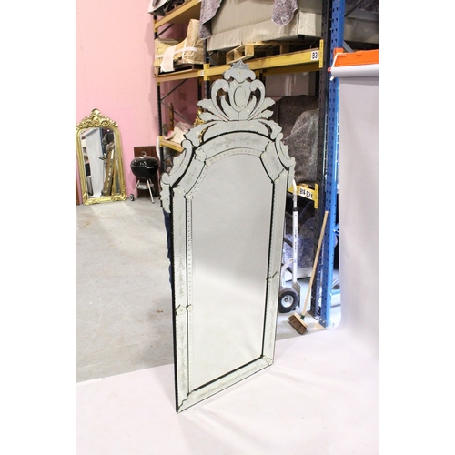 4 - A LARGE VENETIAN MIRROR, bevelled glass in a scrolling mirror frame, 7 ft. 7 in. high, 3 ft. 6 in. w... 