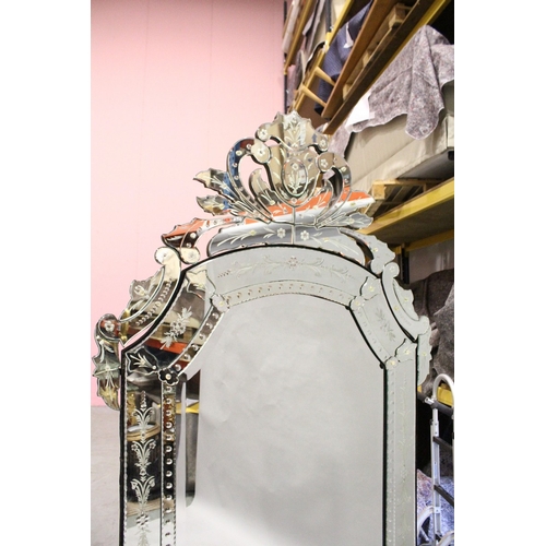 4 - A LARGE VENETIAN MIRROR, bevelled glass in a scrolling mirror frame, 7 ft. 7 in. high, 3 ft. 6 in. w... 