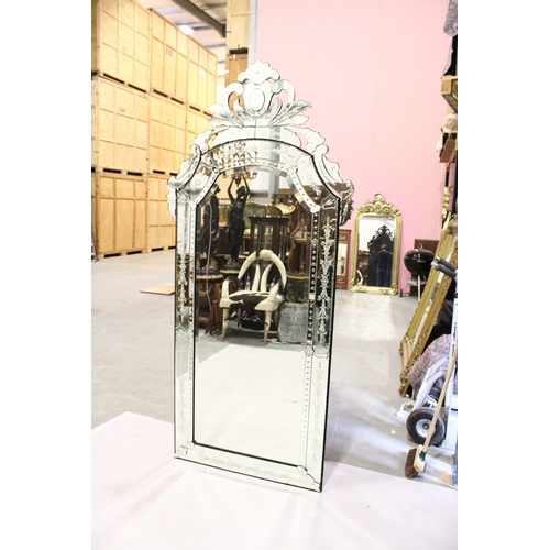 4 - A LARGE VENETIAN MIRROR, bevelled glass in a scrolling mirror frame, 7 ft. 7 in. high, 3 ft. 6 in. w... 