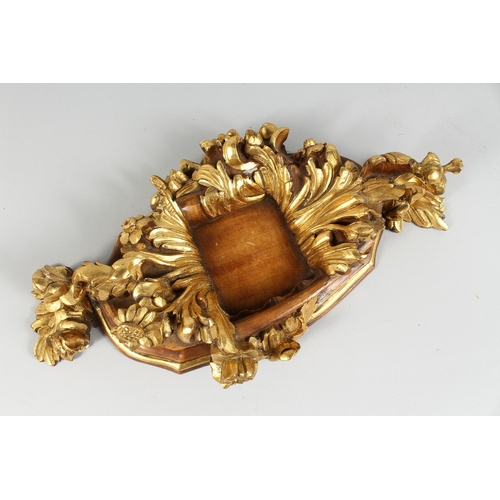 55 - A CARVED GILDED FRAME WITH ACANTHUS CARVING. 20 in. x 10 in.