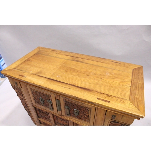 71 - A CHINESE ALTAR TABLE with plain top carved front cupboard doors and drawers, 3 ft. 7 in. long, 1 ft... 