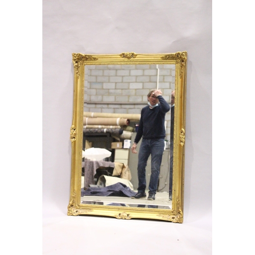 80 - A GILT FRAMED UPRIGHT BEVELLED MIRROR, 3 ft. 5 in. high, 2 ft. 5 in. wide.