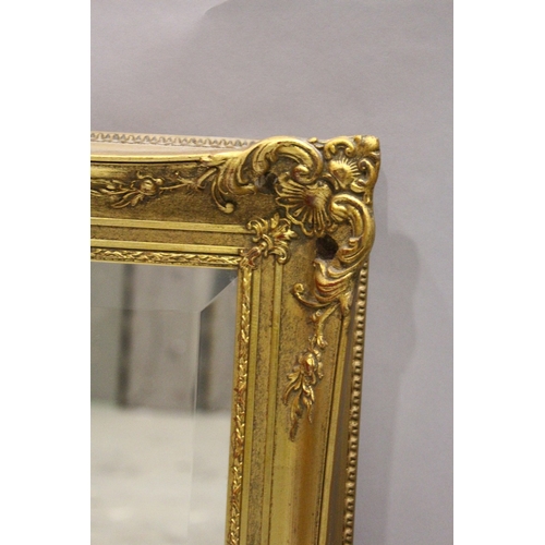 80 - A GILT FRAMED UPRIGHT BEVELLED MIRROR, 3 ft. 5 in. high, 2 ft. 5 in. wide.