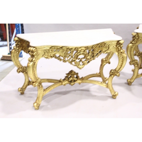 85 - A PAIR OF GILDED AND MARBLE TOP CONSOLE TABLES with white speckled marble tops, gilt bases with curv... 