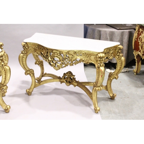 85 - A PAIR OF GILDED AND MARBLE TOP CONSOLE TABLES with white speckled marble tops, gilt bases with curv... 