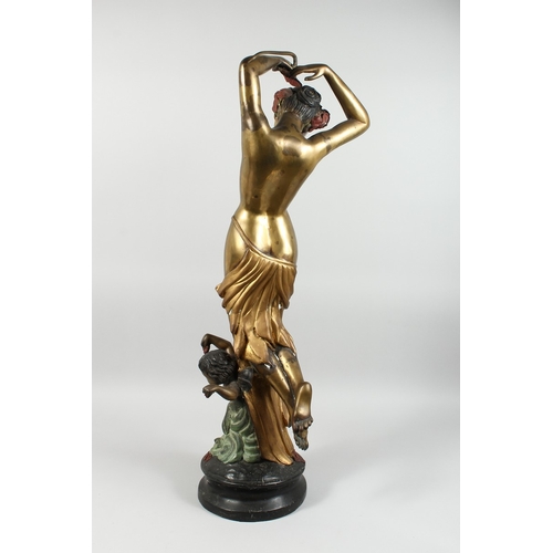 86 - A TWO COLOUR GILDED BRONZE OF A STANDING NUDE  with a cherub on a circular base, 3 ft. 3 in. high.