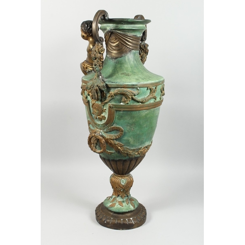 88 - A BRONZE TWO HANDLED URN with cupid, acanthus scroll and laurel leaf handles, 2 ft. 8 in high.