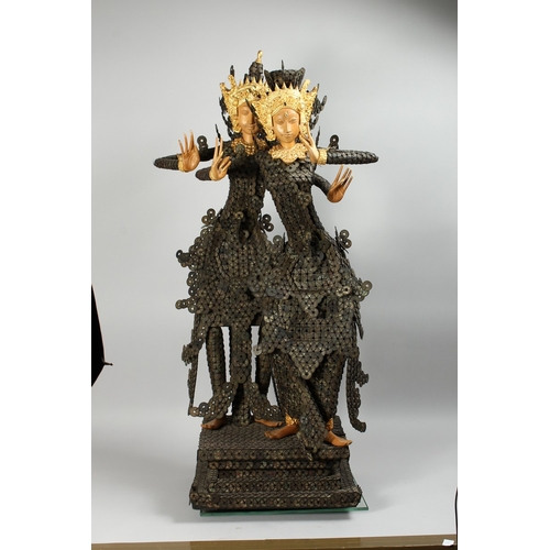 89 - A THAI GROUP OF TWO DANCING FIGURES MODELLED FROM HUNDREDS OF COINS, 3 ft. 6 in. high