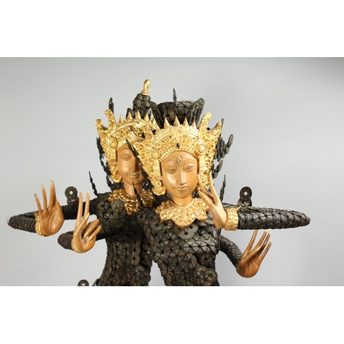 89 - A THAI GROUP OF TWO DANCING FIGURES MODELLED FROM HUNDREDS OF COINS, 3 ft. 6 in. high