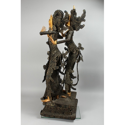 89 - A THAI GROUP OF TWO DANCING FIGURES MODELLED FROM HUNDREDS OF COINS, 3 ft. 6 in. high