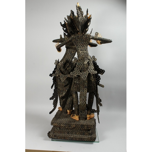 89 - A THAI GROUP OF TWO DANCING FIGURES MODELLED FROM HUNDREDS OF COINS, 3 ft. 6 in. high