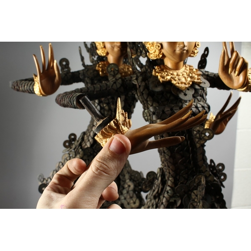 89 - A THAI GROUP OF TWO DANCING FIGURES MODELLED FROM HUNDREDS OF COINS, 3 ft. 6 in. high