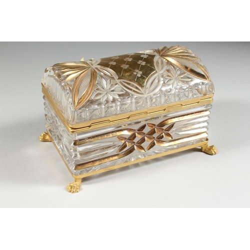 9 - A CUT GLASS AND GILDED CASKET with domed top on clawed feet, 7 in. wide.