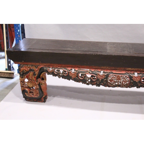 92 - A LONG 17TH / 18TH CENTURY CHINESE ALTAR TABLE, the base carved and pierced with flowers and dragons... 