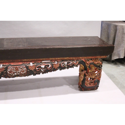 92 - A LONG 17TH / 18TH CENTURY CHINESE ALTAR TABLE, the base carved and pierced with flowers and dragons... 