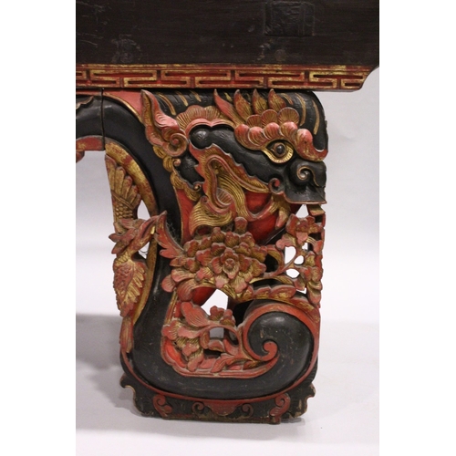 92 - A LONG 17TH / 18TH CENTURY CHINESE ALTAR TABLE, the base carved and pierced with flowers and dragons... 