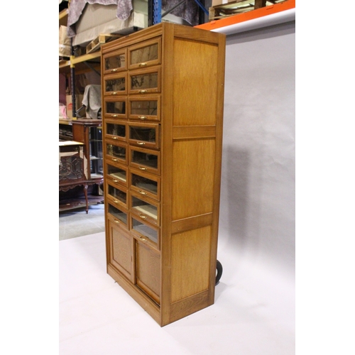 93 - A GOOD HABERDASHERY CABINET  with eight pairs of sliding glass drawers with brass handles.  The base... 