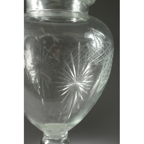 97 - A LARGE PAIR OF CUT GLASS URN, SHAPED VASES AND COVERS, 31 ins. high.