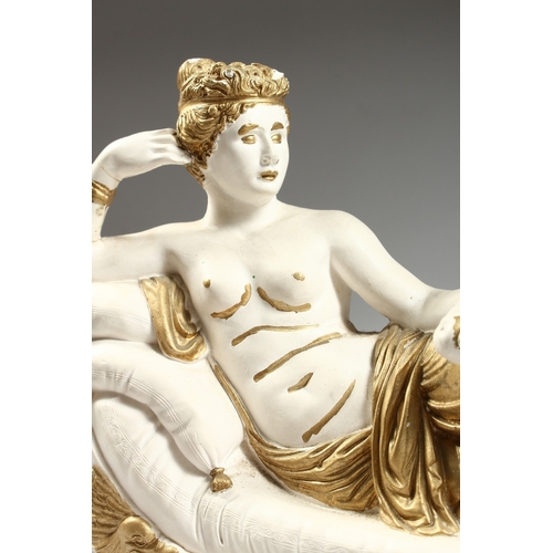 99 - A POTTERY SEMI NUDE on a chaise longue, 15 ins. long