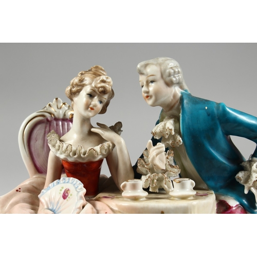 102 - A CONTINENTAL PORCELAIN GROUP GALLANT AND LADY, 8 ins. high.