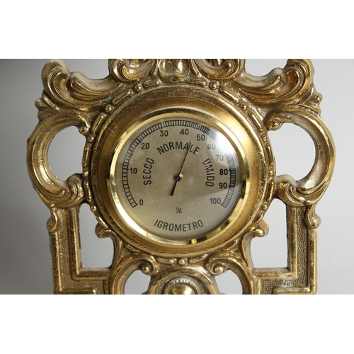 117 - A FOUR DIAL CLOCK BAROMETER in a gilded  frame, 31.5 ins long