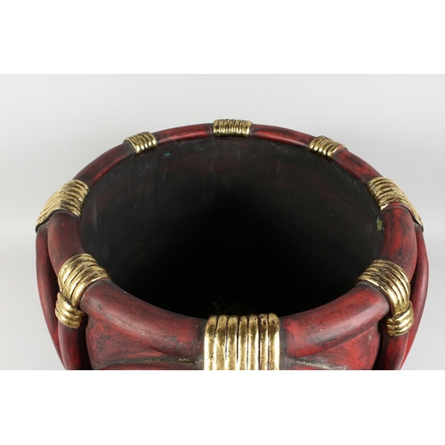 124 - A COMPOSITION RED AND GILT JARDINIERE, 17 ins diameter.