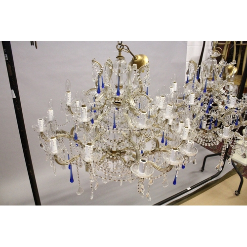 127 - A GOOD LARGE PAIR OF TWO TIER ITALIAN CHANDELIERS with twenty one scrolling branches with prism drop... 