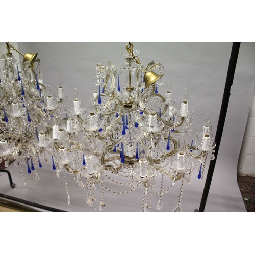 127 - A GOOD LARGE PAIR OF TWO TIER ITALIAN CHANDELIERS with twenty one scrolling branches with prism drop... 