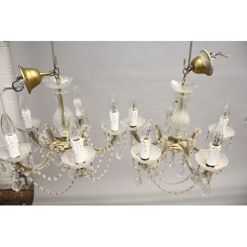 131 - A SMALL PAIR OF ITALIAN GLASS FIVE LIGHT CHANDELIERS with prism drops. 1 ft. 6 ins wide, 1 ft. high.... 