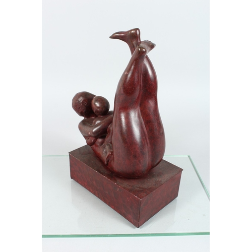 137 - A MODERN BRONZE MOTHER AND CHILD on a rectangular base. 12 ins high.