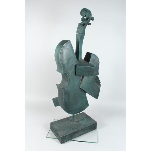 143 - AN ABSTRACT BRONZE CELLO on an rectangular base 34 ins high.