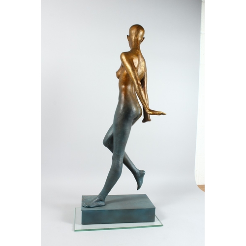 144 - AN ABSRACT STANADING BRONZE NUDE on a rectangular base. 16 ins high.