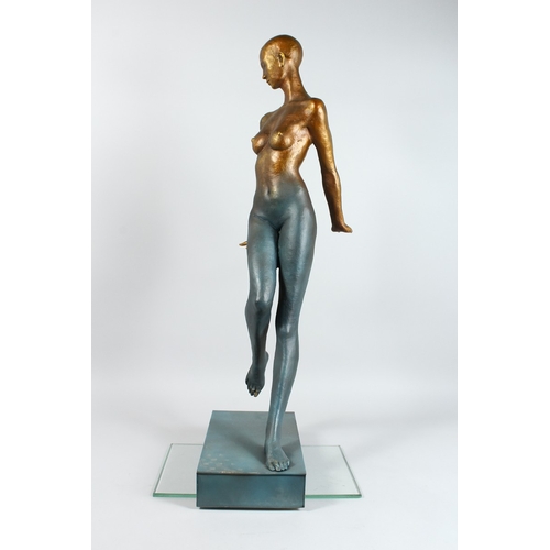 144 - AN ABSRACT STANADING BRONZE NUDE on a rectangular base. 16 ins high.